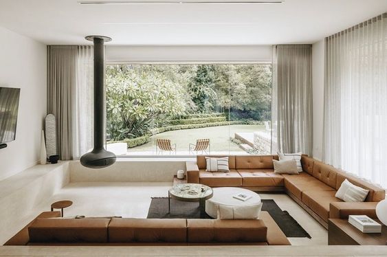 Beige living room with brown sofas and central coffee table, modern home interior design.