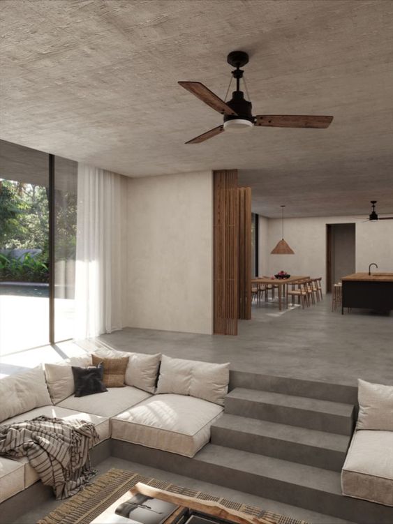 Minimalist modern home in grey and beige tones with open living space and kitchen.