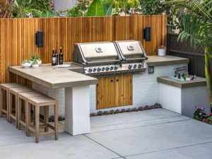 Outdoor BBQ with kitchen benchtop, storage space underneath, and four seats.