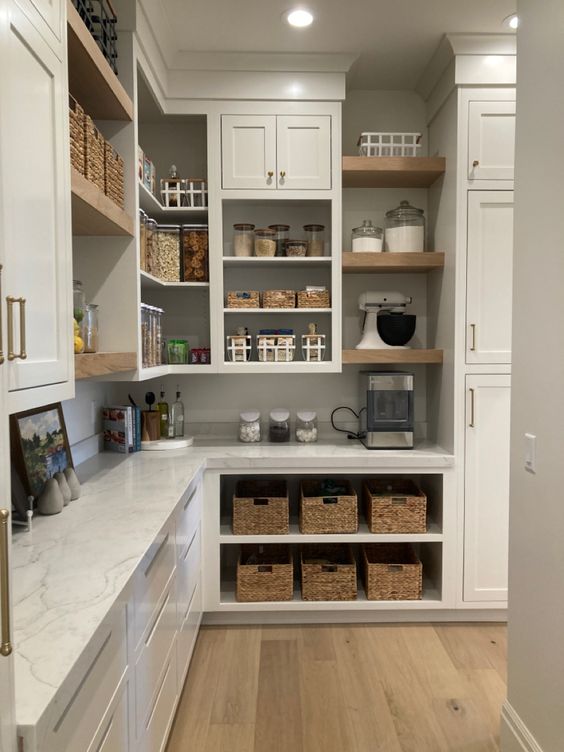 Perfectly organized kitchen with white kitchen cabinets and benchtop.